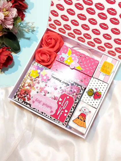I created this pretty pink hamper for a client's fiancée. It's filled with a variety of handmade goodies, including a shaker card, a mini album, and cute pun-filled matchbox notes.