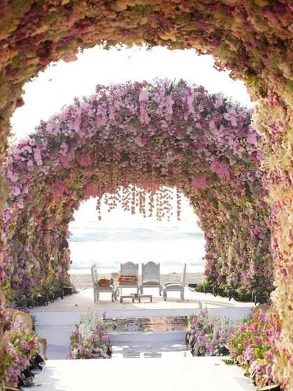 A breathtaking view from within the floral tunnel, looking out towards the wedding ceremony. This perspective highlights the immersive experience we created for the couple and their guests.