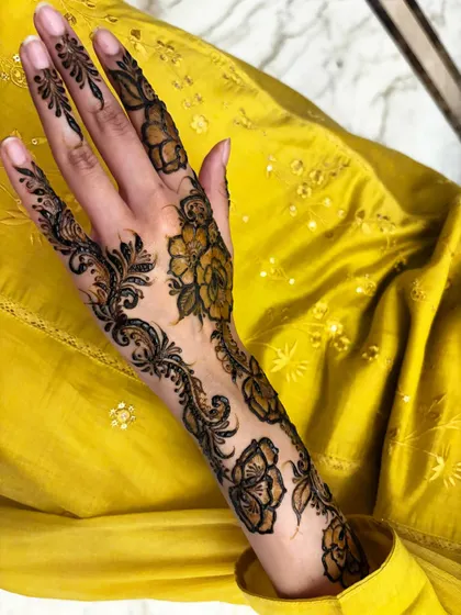 A single-hand view of a floral vine design, showing how it elegantly adorns the hand and arm.