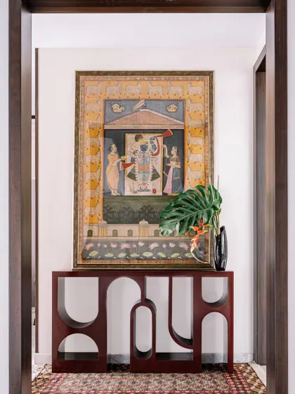 A beautiful Pichwai painting is paired with a contemporary console table. This juxtaposition of old and new, traditional art and modern design, is something I love to explore in my projects.