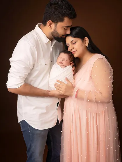 The first family hug. Parents and newborn together, creating a beautiful, emotional portrait that marks the beginning of their life as a family.