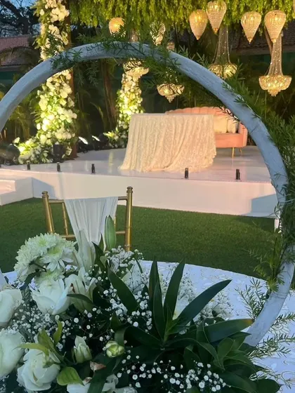 A beautiful tabletop centerpiece featuring a white floral arrangement inside a circular frame, adding a modern touch to the decor.