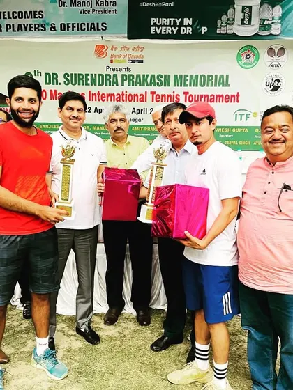 Receiving our trophies at the ITF 400 Masters International Ranking Tournament. It's great to be recognized for our performance.