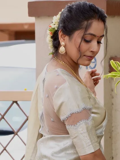 A detailed view of the sheer back blouse I got custom-made to recreate actress Sneha's look. The design features delicate embroidery on the net fabric, creating an elegant and modern feel for a traditional saree.