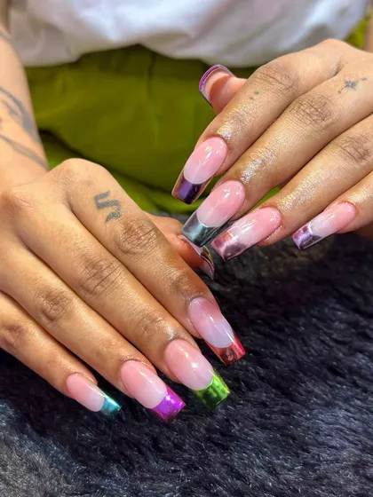 A rainbow at your fingertips. This design puts a colorful spin on the French manicure with multi-colored chrome tips on long, square-shaped extensions. It's a fun and vibrant way to wear a classic style.