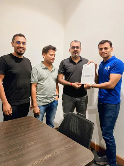 Our team handing over the solar agreement to the committee members of a housing society.