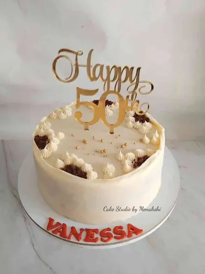 A simple and delicious red velvet cake for a 50th birthday. The design is kept elegant with a custom gold topper, letting the flavor be the star of the show.