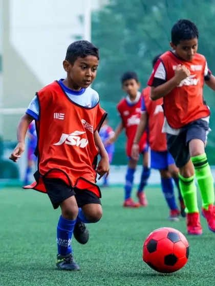 A young player dribbles with determination during a training match at our Mathikere centre.