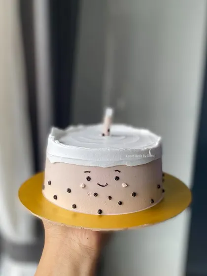 A simple and adorable mini cake with a cute smiling face. Perfect for a small, happy celebration or just to brighten someone's day.