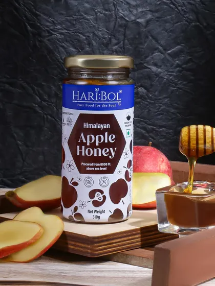 This image for Himalayan Apple Honey uses fresh apples and a dark background to create a dramatic contrast. The dripping honey accentuates its viscous texture and rich quality.