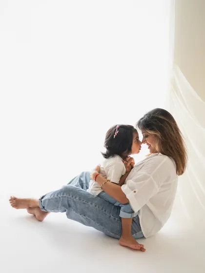 An incredibly sweet and intimate moment between a mother and her daughter, nose to nose. The minimalist setting allows their bond to be the star of the show.