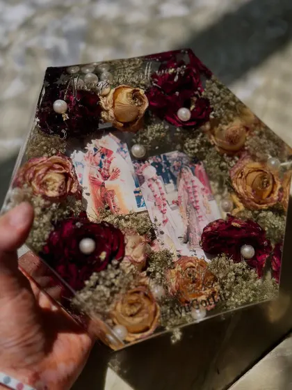This hexagonal keepsake holds multiple photos from the wedding day, surrounded by a mix of red and cream roses. It’s a wonderful way to tell a bigger story and include more of your favorite moments in one piece.