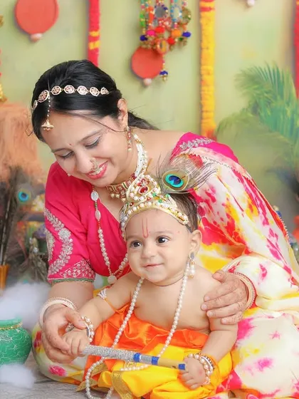 A happy baby Krishna with his loving mother. The smiles in these photos are always so genuine and heartwarming.