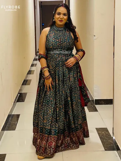 Twirl into tradition with a touch of glam. This client looks stunning in a dark green printed Anarkali-style lehenga, perfect for a festive celebration.