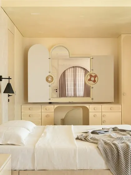 The master suite in our Soft Serve project is enveloped in a timeless taupe hue. A custom-designed vanity and wardrobe unit with geometric patterns creates a focal point.