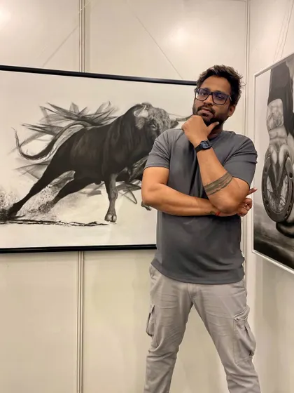 A photo of me standing next to my bull painting 'Mighty Rush' at an art show.
