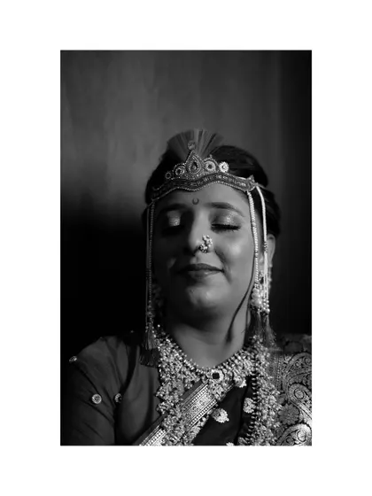 A serene black and white portrait of the bride, Suparna, in her traditional Maharashtrian bridal look, capturing a moment of quiet contemplation.