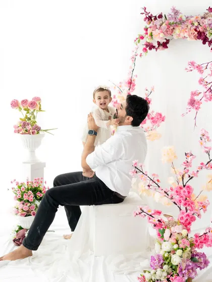 A father's joy. This candid shot of a dad lifting his laughing daughter is what family photography is all about for us, capturing pure, unposed happiness.
