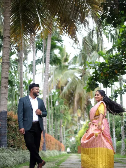 A beautiful, natural portrait taken in a lush green pathway. We focus on capturing candid interactions and smiles, making the pre-wedding shoot a fun and memorable experience.