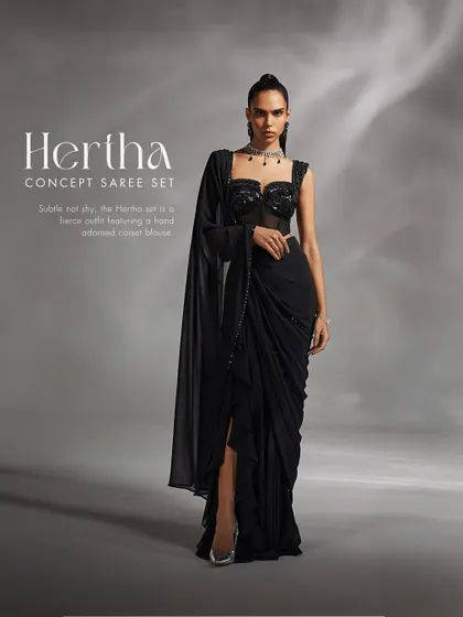 The Hertha Concept Saree in timeless black. This fierce and modern outfit features a hand-adorned corset blouse paired with a pre-draped concept saree, designed to amplify your look with sophisticated elegance.