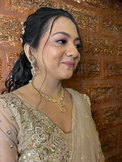 A profile shot showing how the makeup and hair come together for a beautiful sangeet look.