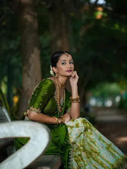 A candid moment showing the beautiful details of the custom green half saree.