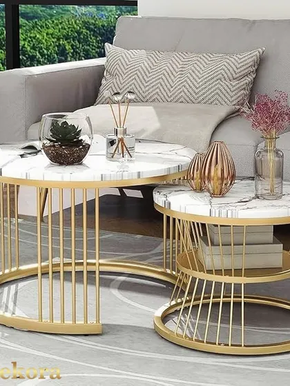 This contemporary nesting table set features a larger C-shaped table and a smaller round table, both with gold-finish wireframe bases. The white marble-finish tops provide a clean, luxurious look for modern living rooms.