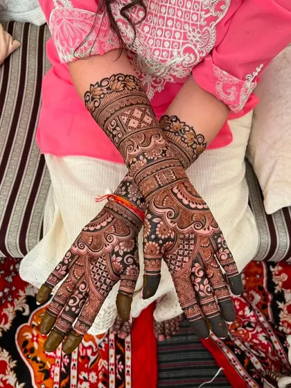 This photo shows the beautiful dark stain of an intricate bridal design. The color is rich and even across both hands.