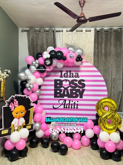 A "Boss Baby Girl" theme for Aditi's birthday. This unique take on the theme uses pink, black, and white with a striped backdrop and a custom cutout.