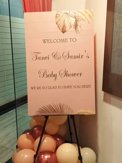 A personalized welcome sign on an easel for Tanvi & Samir's baby shower, adding a personal touch to the event entrance.
