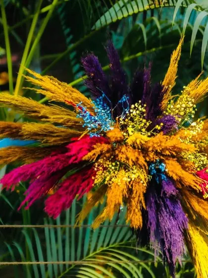 Another detail of the colorful dried floral arrangements used throughout the carnival-themed event, adding texture and a burst of color.