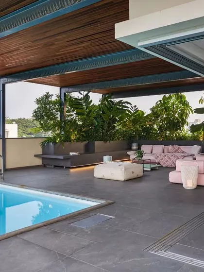 The rooftop pool and lounge at Kanasu, an urban oasis designed for relaxation and entertainment.