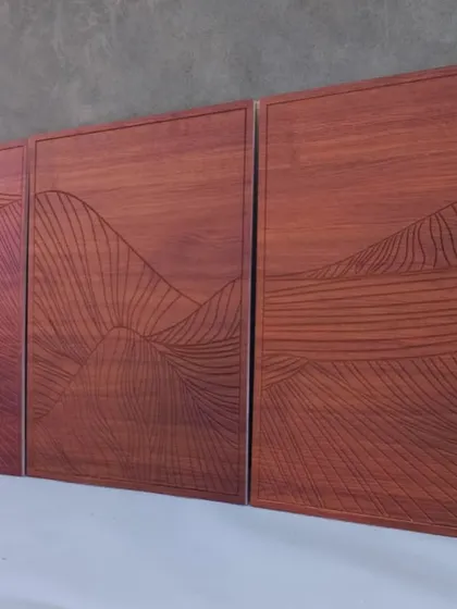 An angled view of the brown triptych, emphasizing its scale and the warm tones of the wood finish.