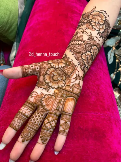 A close-up of a dense Indo-Arabic design. The combination of shaded flowers, delicate leaves, and geometric patterns on the fingers and palm showcases a high level of detail.