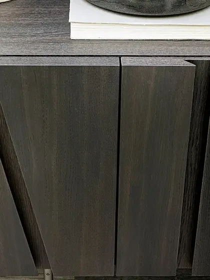 A close-up of the seventies-inspired sideboard, showing the detail of the engraved door surfaces that create an abstract effect of shadows.