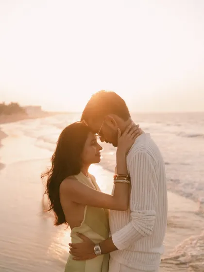 Bathed in the golden hour light of a Muscat sunset, this is a moment of pure connection. An intimate embrace on the beach, with the soft glow of the sun creating a warm, timeless silhouette. This is the quiet, powerful intimacy I seek in every pre-wedding portrait.