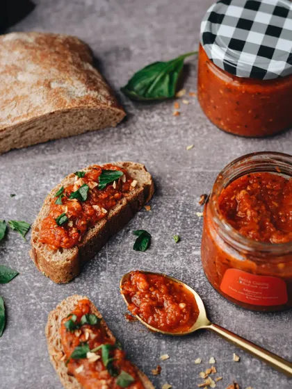 A rustic, appetizing shot for Bella Cucina, featuring their marinara sauce on freshly baked bread with basil.