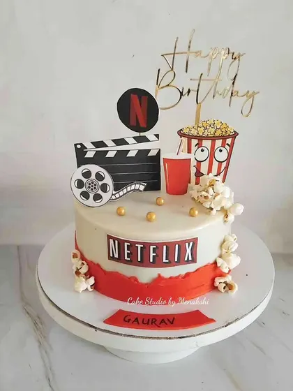 For someone who loves to chill with Netflix, this cake is the perfect treat. It comes complete with popcorn, a drink, and a movie clapperboard.
