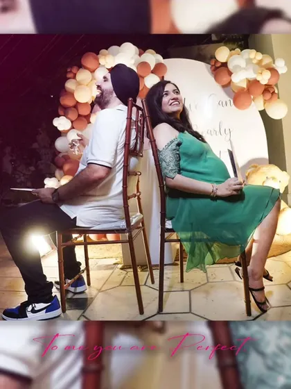 The happy parents-to-be enjoying a fun game at their baby shower, a candid moment filled with joy and anticipation.