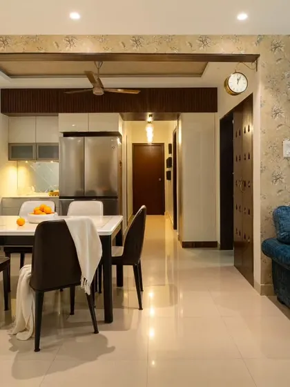 A full view of the 'Blue Elegance' living and dining space, showing how the reupholstered sofa, new dining set, and updated cabinetry come together to create a cohesive and elegant home.