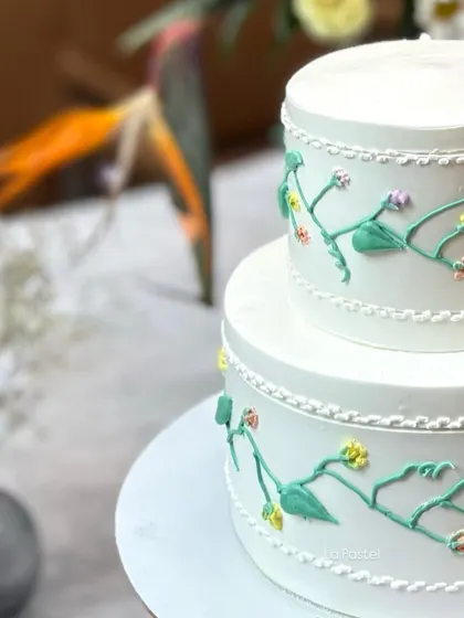 A close-up of the delicate piped vine details on this two-tier anniversary cake.