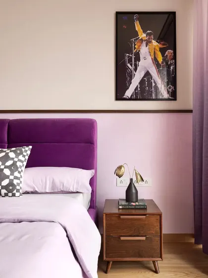 This shot shows the Freddie Mercury print, a personal touch that celebrates the client's love for music, perfectly complementing the room's purple color scheme.