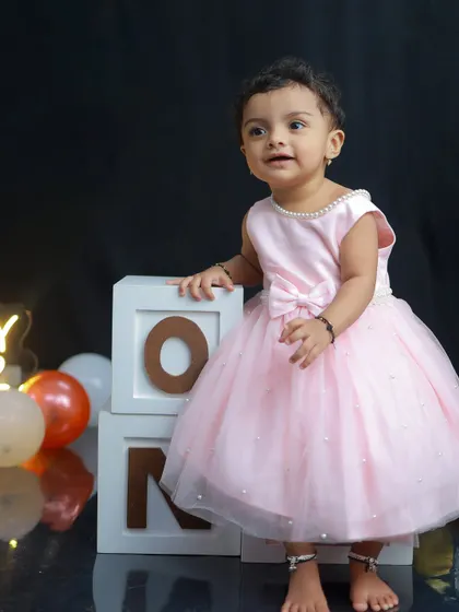 Before the cake smash begins, I always capture some clean, classic portraits. This little girl in her pretty pink dress, standing by the 'ONE' blocks, looks like a true birthday princess.