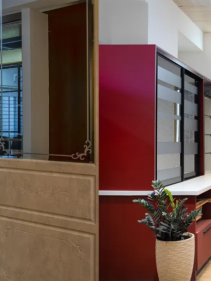 A glimpse into my experience center, where you can see different materials side-by-side. Here, a bold red crockery unit contrasts with a more traditional wood and mirror door panel.