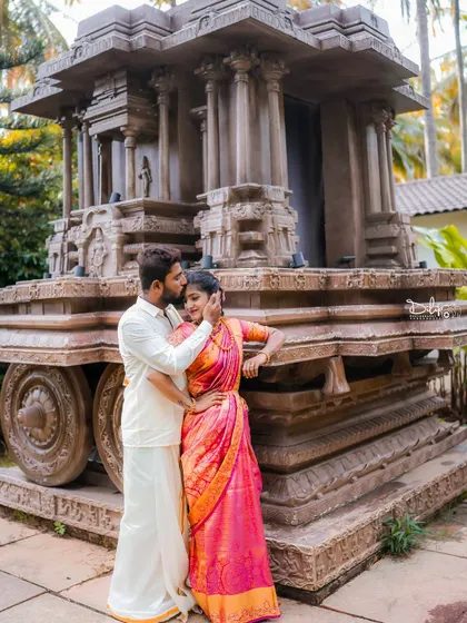 An intimate moment by the stone chariot, a perfect blend of love and heritage.