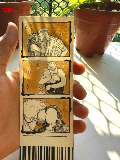 Another look at a completed photo strip, held up to catch the light. You can see the texture of the paper and the variations in the coffee stain, making each one unique.