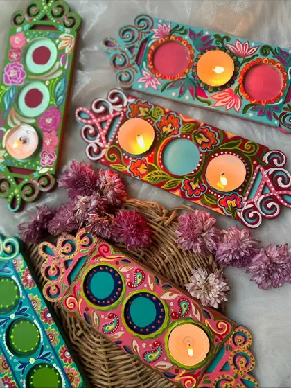 Introducing our new hand painted tea light holders, available in a set of three. These intricate, colorful designs are perfect for adding a festive touch to your home decor.