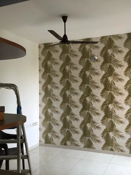 Another view of the palm leaf wallpaper installation, showing how it brightens up the corner of a room.