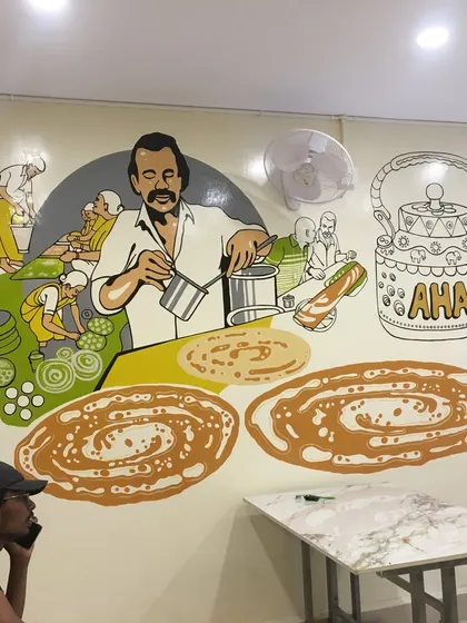 This part of the restaurant mural shows a chef preparing jalebis and other sweets. Our illustrative art is great for visually explaining the food and heritage of an establishment.