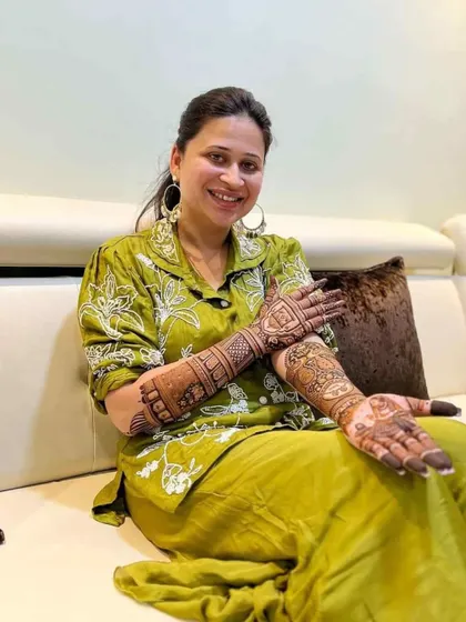 A smiling client posing on her sofa, showing the convenience of my home service.